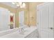Bathroom featuring a large mirror, a vanity with a sink, and a separate room with a door at 20 Balfour Dr, Covington, GA 30014