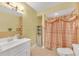 A bathroom features a white sink vanity, a storage cabinet, and a shower-tub combo at 20 Balfour Dr, Covington, GA 30014
