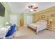 A bedroom features natural light, a ceiling fan, carpeted floors, and neutral colored walls at 20 Balfour Dr, Covington, GA 30014
