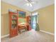 Bedroom featuring two wooden bookcases, a desk, and a window with curtains at 20 Balfour Dr, Covington, GA 30014