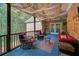 Relaxing covered patio with brick wall, string lights, comfortable seating, and a decorative ceiling fabric at 20 Balfour Dr, Covington, GA 30014