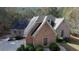 Aerial view of a brick home with a well-maintained roof and mature trees surrounding the property at 20 Balfour Dr, Covington, GA 30014