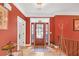Inviting foyer with decorative glass front door, light wood flooring, and coat rack at 20 Balfour Dr, Covington, GA 30014