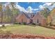 Charming brick home with manicured lawn and mature trees on a sunny day at 20 Balfour Dr, Covington, GA 30014