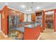 Open kitchen featuring stainless steel appliances, wooden cabinets, island, and adjacent wine storage at 20 Balfour Dr, Covington, GA 30014