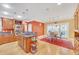 Bright eat-in kitchen features wooden cabinets, stainless steel appliances, and a central island with cooktop at 20 Balfour Dr, Covington, GA 30014