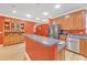 Kitchen featuring stainless steel appliances, wooden cabinets, a central island, and modern lighting at 20 Balfour Dr, Covington, GA 30014