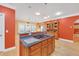 Kitchen island with cooktop and seating, flowing into dining area with outdoor access at 20 Balfour Dr, Covington, GA 30014