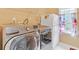 Laundry room with front load washer and dryer and view to outside at 20 Balfour Dr, Covington, GA 30014