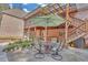 Relaxing patio area with umbrella-covered table, chairs, and a covered deck on a beautiful brick home at 20 Balfour Dr, Covington, GA 30014