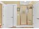 Bathroom shower with a glass door, white door, neutral wall color, and tiled floor at 20 Balfour Dr, Covington, GA 30014