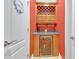 Charming wine storage area featuring a wine refrigerator, display shelves, and glassware storage at 20 Balfour Dr, Covington, GA 30014