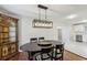 Dining room featuring a modern light fixture, a round table, and views into the kitchen at 2265 Starline Dr, Decatur, GA 30032