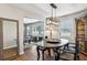 Open dining room featuring a vintage hutch, a modern chandelier, and a view into the living room at 2265 Starline Dr, Decatur, GA 30032