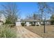 Charming exterior view of the home, surrounded by lush landscaping and mature trees at 2265 Starline Dr, Decatur, GA 30032