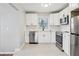 Modern kitchen featuring stainless steel appliances, white cabinets, and tile floors at 2265 Starline Dr, Decatur, GA 30032