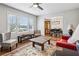 Bright living room with large window, a ceiling fan, hardwood floors, and stylish furniture at 2265 Starline Dr, Decatur, GA 30032