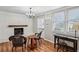 Cozy living room with a painted brick fireplace, wood mantle, and hardwood floors at 2265 Starline Dr, Decatur, GA 30032