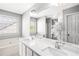 Bright bathroom with double vanity, quartz countertop, large mirror, and soaking tub at 4606 Liberty Square Dr, Acworth, GA 30101