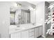 Bright bathroom featuring dual sinks, white cabinets, and a large mirror at 4606 Liberty Square Dr, Acworth, GA 30101