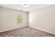 Cozy bedroom featuring neutral walls, plush carpet, and a window bringing in natural light at 4606 Liberty Square Dr, Acworth, GA 30101