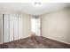 Neutral bedroom featuring plush carpet, a closet, and an open doorway at 4606 Liberty Square Dr, Acworth, GA 30101