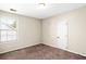 Cozy bedroom with neutral walls, carpet flooring, and a window at 4606 Liberty Square Dr, Acworth, GA 30101