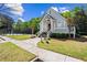 Charming clubhouse exterior featuring a welcoming entrance, landscaped surroundings, and a tennis court at 4606 Liberty Square Dr, Acworth, GA 30101