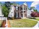 Side view of a two story brick house with white siding, picket fence, and mature trees at 4606 Liberty Square Dr, Acworth, GA 30101