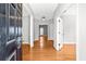 Bright foyer with hardwood floors and natural light streaming in from the doorway at the end of the hall at 4606 Liberty Square Dr, Acworth, GA 30101