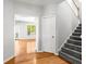 View of foyer featuring hardwood floors, staircase, and a glimpse into a well-lit living area at 4606 Liberty Square Dr, Acworth, GA 30101