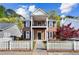 Charming two-story brick home featuring a cozy front porch, black shutters, and a picket fence at 4606 Liberty Square Dr, Acworth, GA 30101