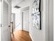 Hallway featuring hardwood floors, neutral walls, and an accent wall mirror at 4606 Liberty Square Dr, Acworth, GA 30101