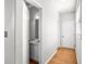Bright hallway featuring a powder room, tile floors, and plenty of natural light at 4606 Liberty Square Dr, Acworth, GA 30101