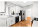 Bright kitchen featuring white cabinets, stainless steel appliances, and hardwood floors at 4606 Liberty Square Dr, Acworth, GA 30101