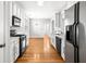Galley kitchen with white cabinets, stainless steel appliances, and hardwood floors at 4606 Liberty Square Dr, Acworth, GA 30101