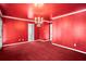 Red living room featuring unique color scheme and chandelier at 4606 Liberty Square Dr, Acworth, GA 30101