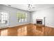 Bright living room featuring hardwood floors, a fireplace, and a large window providing natural light at 4606 Liberty Square Dr, Acworth, GA 30101