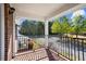 View from a porch featuring iron railings and a view of the landscaped front yard and street at 4606 Liberty Square Dr, Acworth, GA 30101