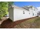 Side exterior of the home with white siding and manicured landscaping at 4606 Liberty Square Dr, Acworth, GA 30101