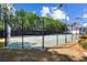 Well-maintained tennis court surrounded by lush greenery and secure fencing for recreational enjoyment at 4606 Liberty Square Dr, Acworth, GA 30101