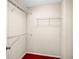 Empty walk-in closet with wire shelving and red carpet at 4606 Liberty Square Dr, Acworth, GA 30101