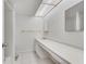 Bright bathroom featuring a long countertop, white cabinets, and tile flooring with a skylight at 6851 Roswell Rd # A21, Sandy Springs, GA 30328