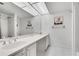 Bright bathroom features a double vanity, shower, decorative artwork, and modern lighting at 6851 Roswell Rd # A21, Sandy Springs, GA 30328
