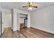 Bedroom with hardwood floors, neutral paint, ceiling fan, and closet access at 6851 Roswell Rd # A21, Sandy Springs, GA 30328