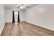 Spacious bedroom featuring hardwood floors, neutral paint, ceiling fan, and a sunny window at 6851 Roswell Rd # A21, Sandy Springs, GA 30328