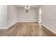 Bright dining room with white walls, modern lighting fixture, and hardwood flooring at 6851 Roswell Rd # A21, Sandy Springs, GA 30328