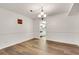 Bright dining room with white walls, modern lighting fixture, and hardwood flooring at 6851 Roswell Rd # A21, Sandy Springs, GA 30328