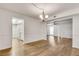 Cozy dining area with wood floors and a chandelier, transitioning into the kitchen and living room at 6851 Roswell Rd # A21, Sandy Springs, GA 30328