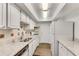 Bright kitchen featuring white cabinets, granite counters, stainless steel sink, and gas range at 6851 Roswell Rd # A21, Sandy Springs, GA 30328